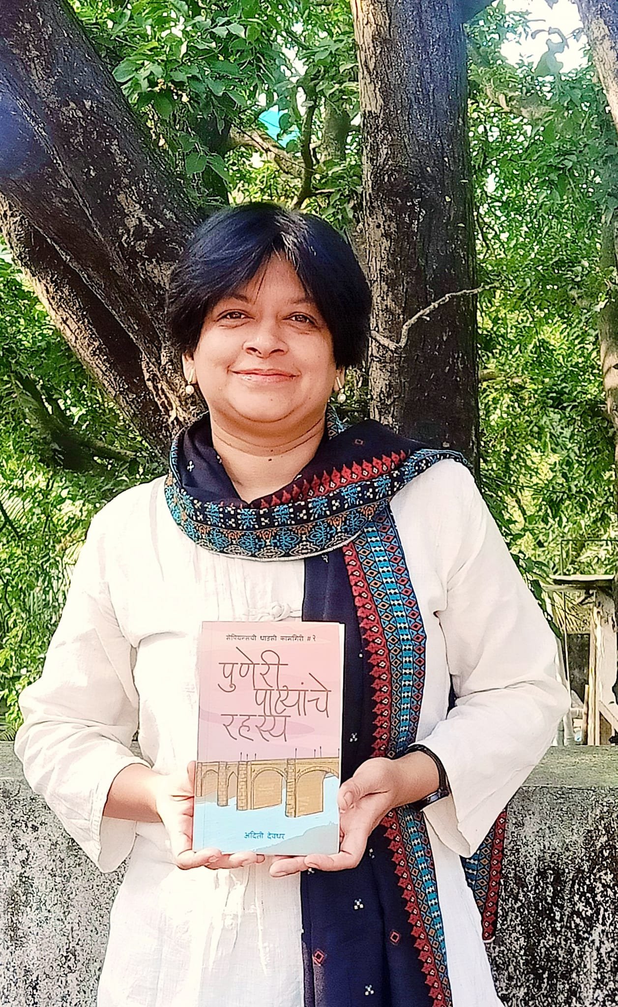 Photo of a writer holding her book